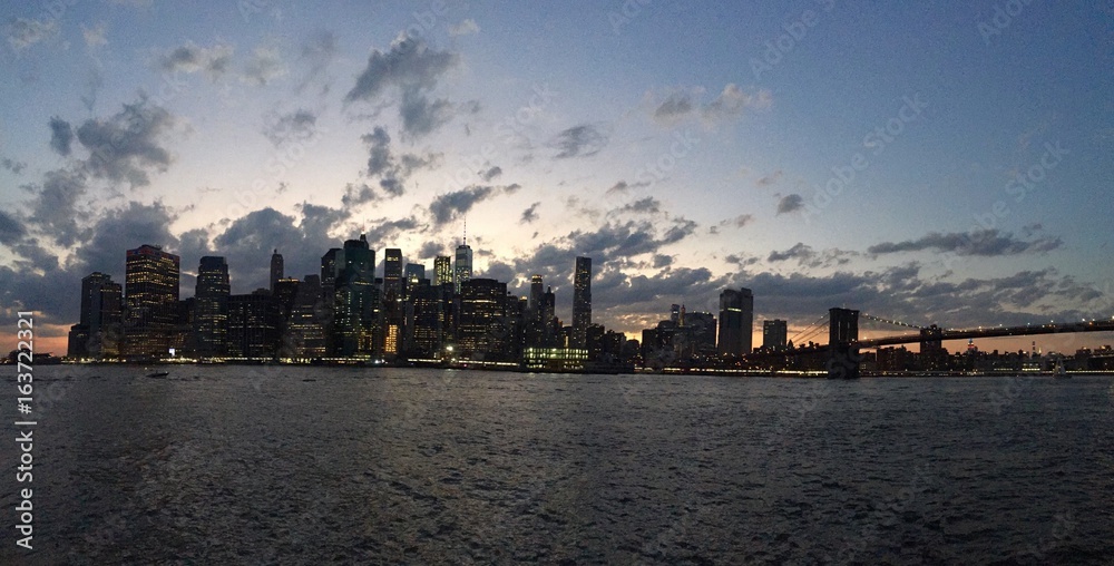 Manhattan over river before sunset in panorama