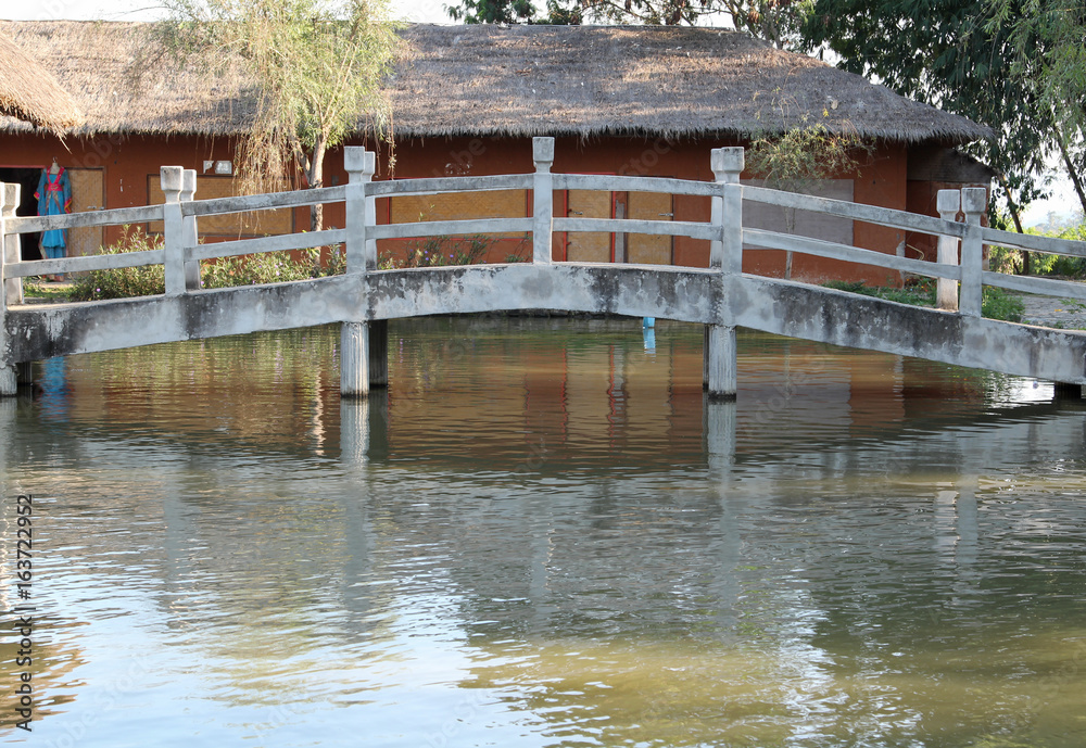 The old concrete footbridge across the pond.
