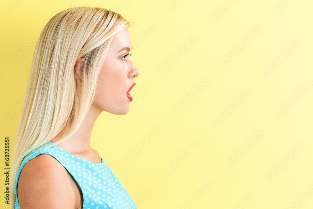 Profile of a young woman on a yellow background Profile of a young woman on a yellow background