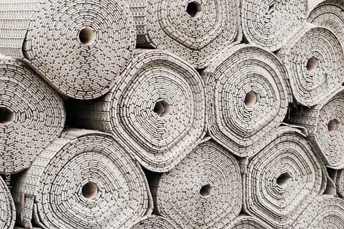 Rolls of white fabric with patterns