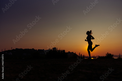 The woman does exercises at sunrise. © Anastasiia