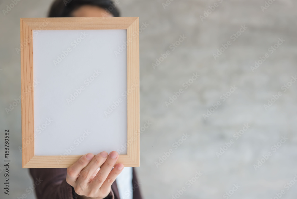 Blank wooden photo Frame in the woman's hand . Blank wooden photo Frame in the woman's hand .