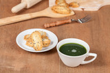 Hot and fresh green tea on wood with home made a small sweet cookie with black sesame.