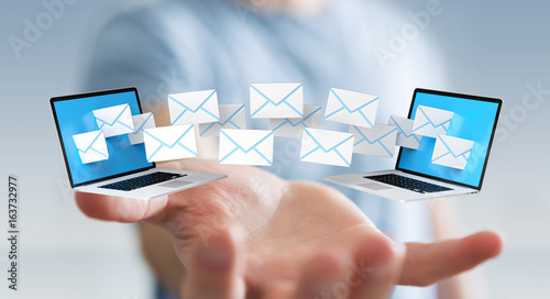 Fotografie Businessman receiving e-mails on his digital devices 3D rendering