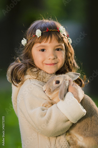 beautiful girl with a rabbit in the woods