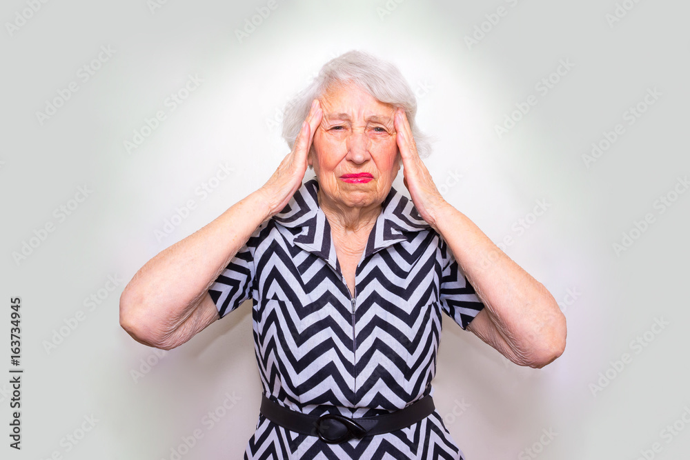 Senior Woman With Head In Hands Looking Weary Senior Woman With Head In Hands Looking Weary