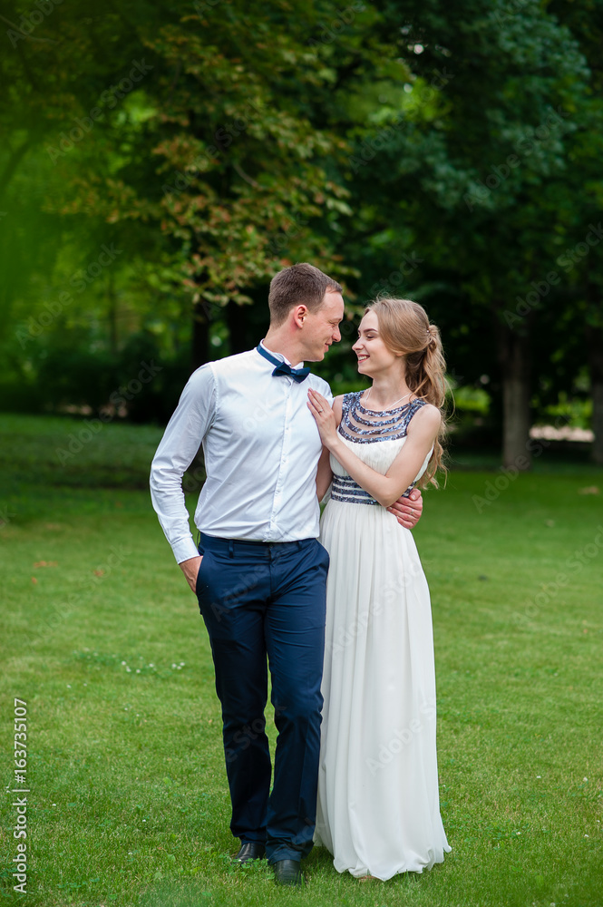 A married couple is walking and hugging in the park. A married couple is walking and hugging in the park.