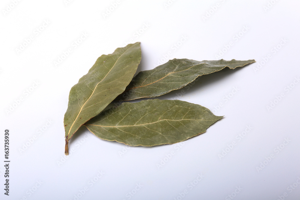 Aromatic dried bay leaves on white background. Aromatic dried bay leaves on white background.