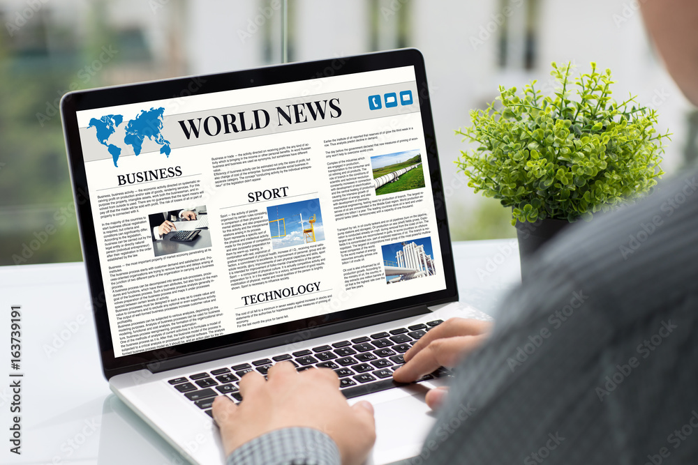 Man hands holding computer with app world news screen cafe Man hands holding computer with app world news screen cafe