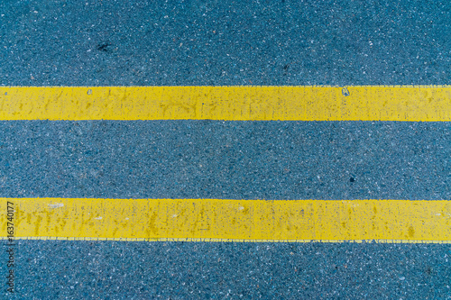 Double yellow line on the road texture © momolelouch