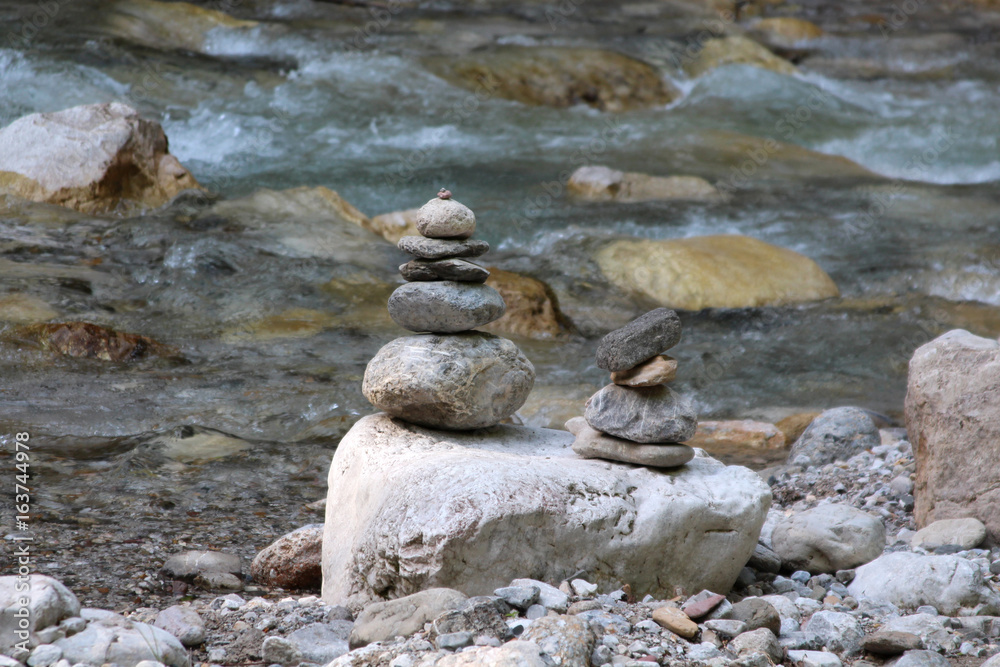a pyramid of stones near the mountain river a pyramid of stones near the mountain river