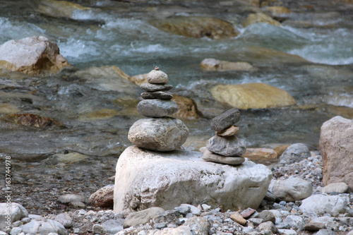 a pyramid of stones near the mountain river