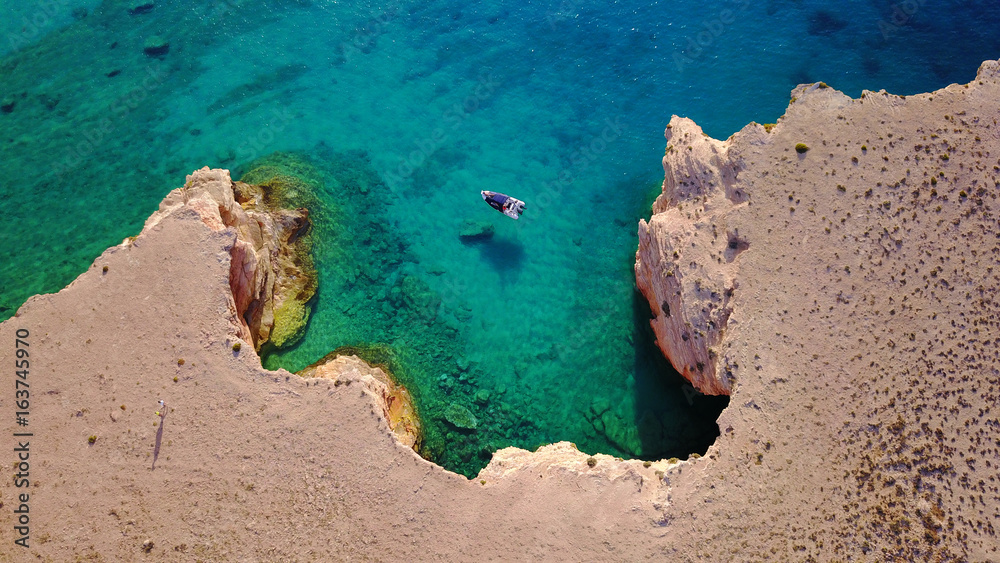 Aerial drone photo of famous caves of Ksylobatis near Pori beach, Koufonissi island. Cyclades, Greece Aerial drone photo of famous caves of Ksylobatis near Pori beach, Koufonissi island. Cyclades, Greece