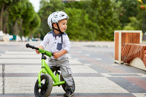 boy in a helmet riding bike photo