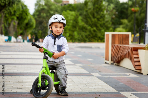 boy in a helmet riding bike photo