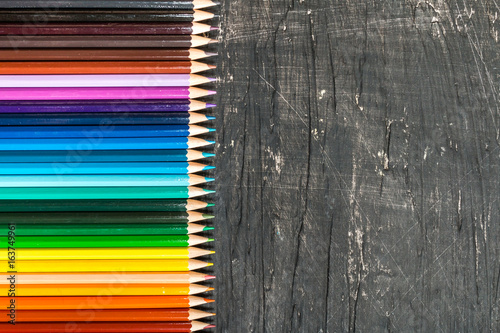 multicolored pensils and chalk board photo