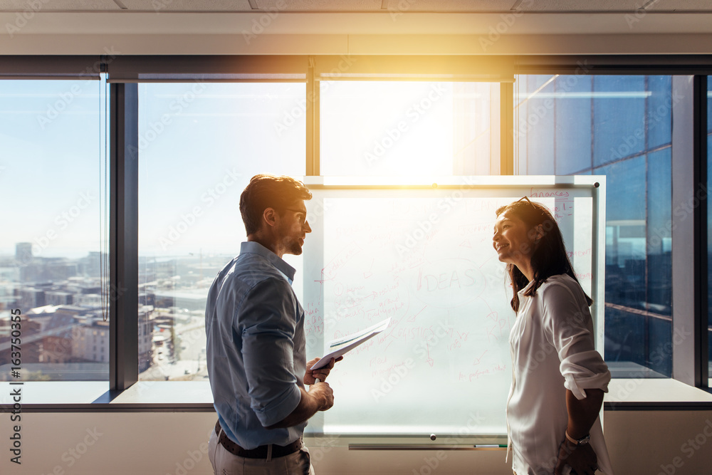 Business colleagues discussing business in office. Business colleagues discussing business in office.