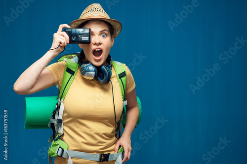 Surprising woman traveler taking pictures with photo camera © Yuriy Shevtsov