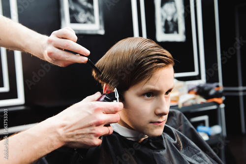 cute young boy getting a haircut