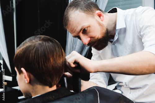 cute young boy getting a haircut