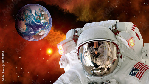 Astronaut planet Earth spaceman helmet stars space suit galaxy universe. Elements of this image furnished by NASA.