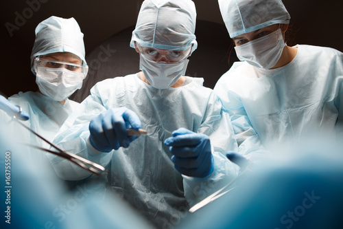 Photo of surgeons with instruments photo