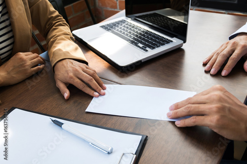Photos business man giving resignation letter to human resource manager