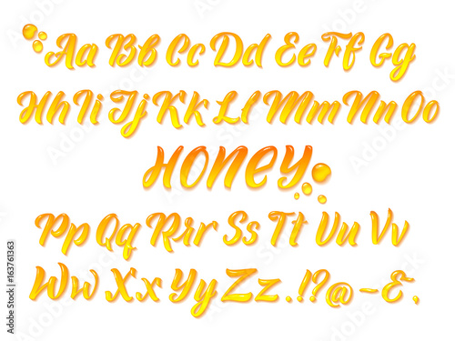 Liquid honeyed latin alphabet with gold splashes. Hand writing yellow letters vector set