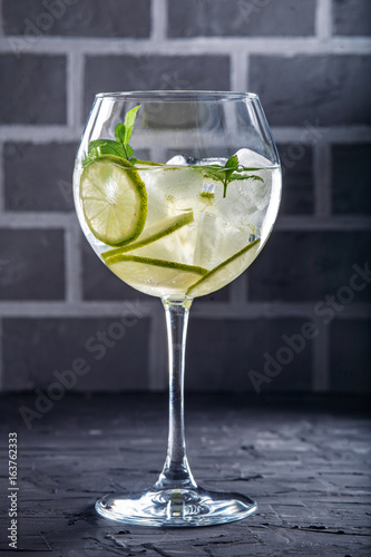 Cocktail with lime and mint. Concept of drinks and alcohol.