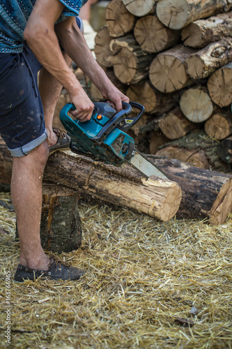 Man chopping wood with a chainsaw