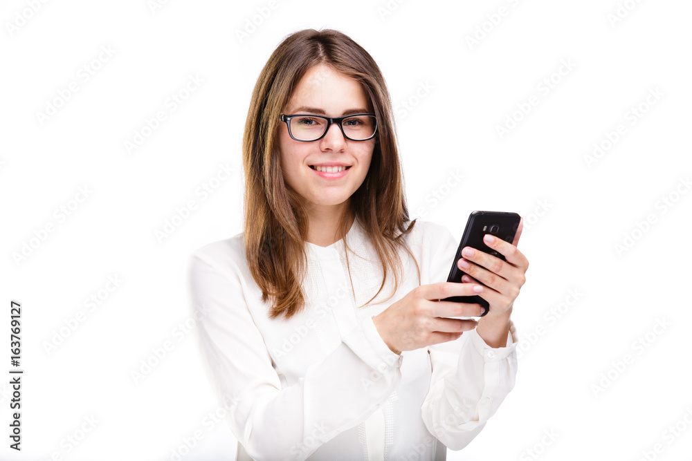 Portrait happy, smiling woman texting on her smart phone, isolated white background. Communication concept. Internet, phone addiction