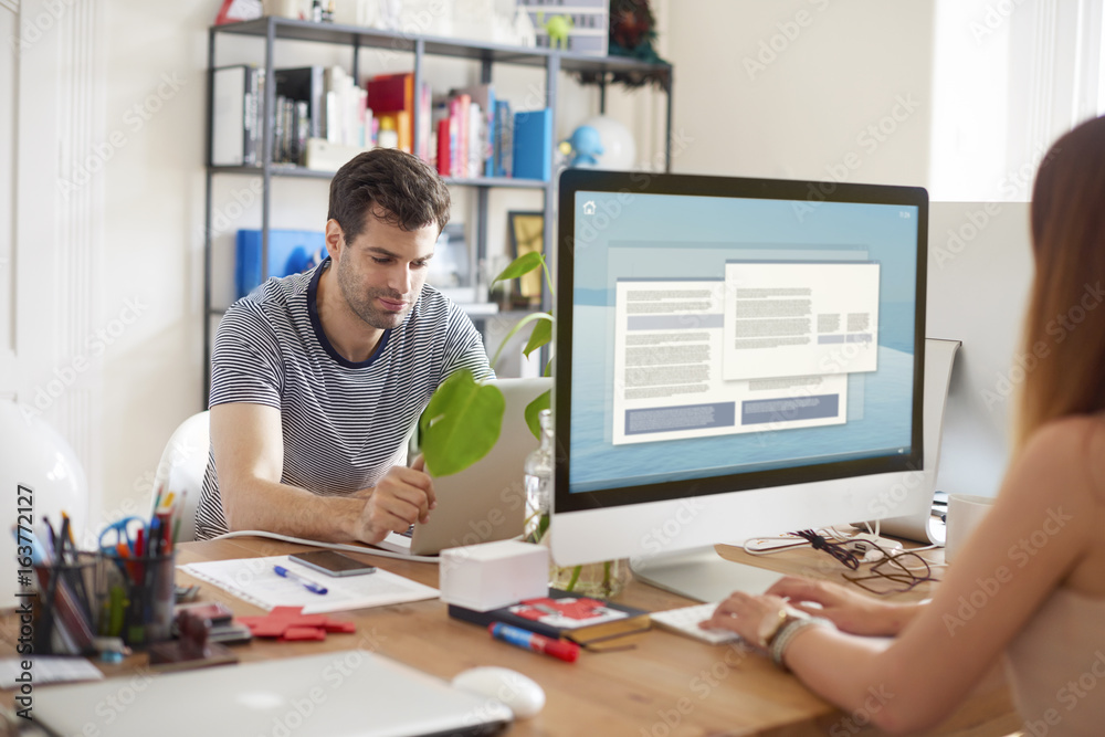 Working online. Confident young professional man at office. Working online. Confident young professional man at office.