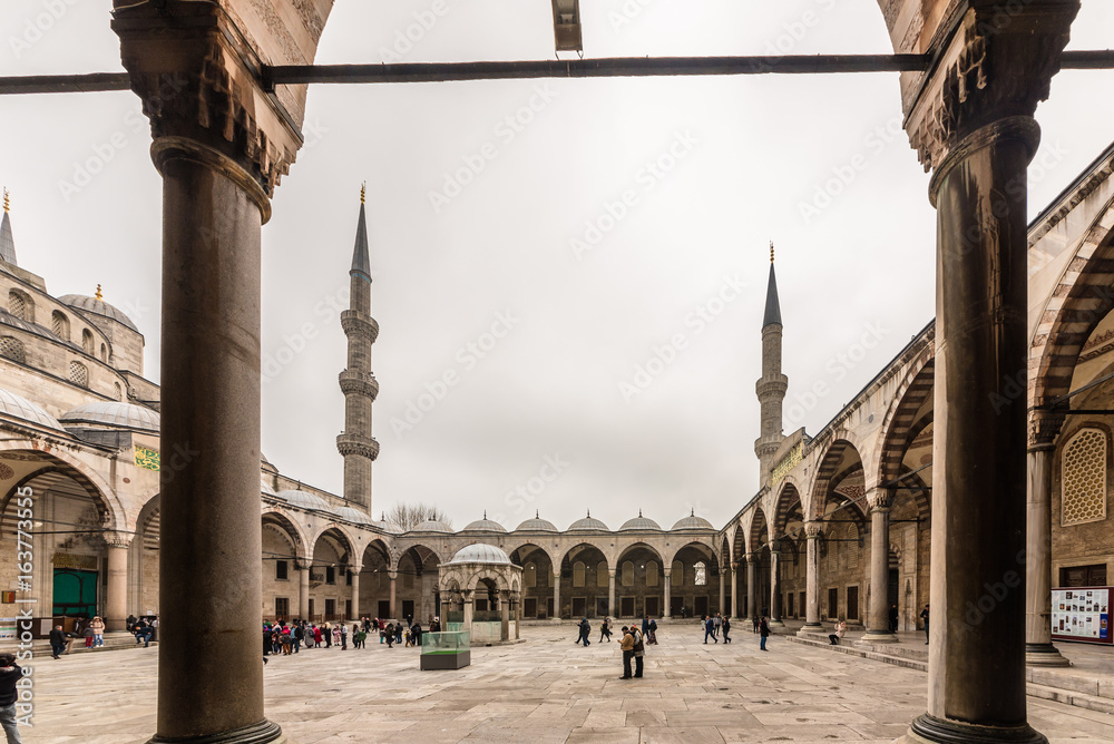 Fototapeta premium View from the outside,inner courtyard and archway of blue Mosque also called Sultan Ahmed Mosque or Sultan Ahmet Mosque in Istanbul, Turkey