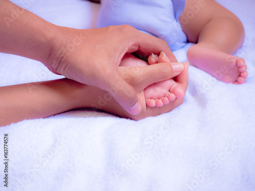 Baby feet in Parents hand. Family is love for Baby concept.
