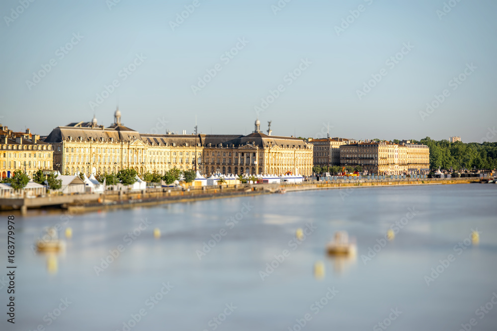 View on Garonne river and riverside with La Bourse square in Bordeaux city, France. Image with tilt-shift technic