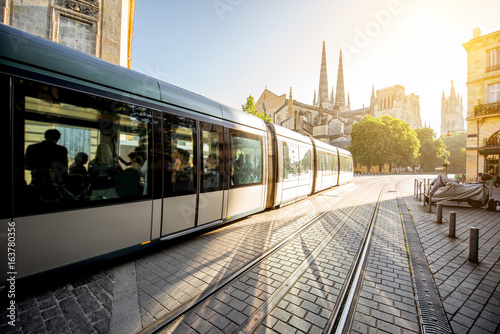 Morning street view with tram and saint Pierre cathedral in Bordeaux city, France