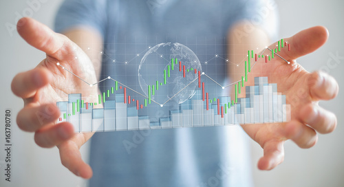 Businessman using digital 3D rendered stock exchange stats and charts
