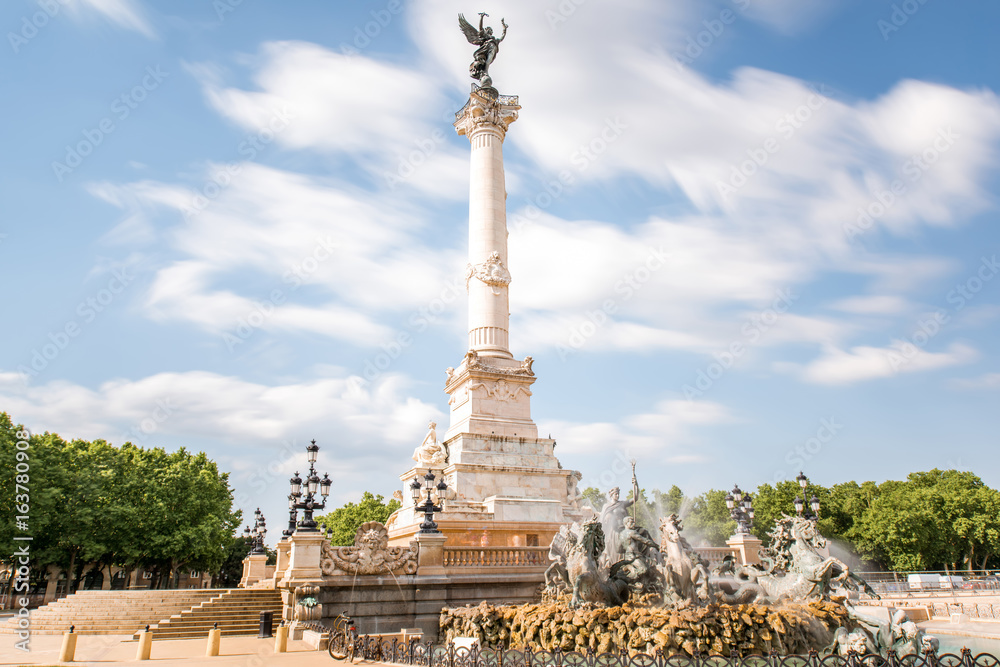 View on the Quinconces square with Girondins fountain in Bordeaux city in France. Long exposure image technic with motion blurred clouds