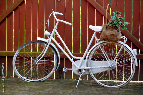 White bicycle on a wooden fence background © wideonet