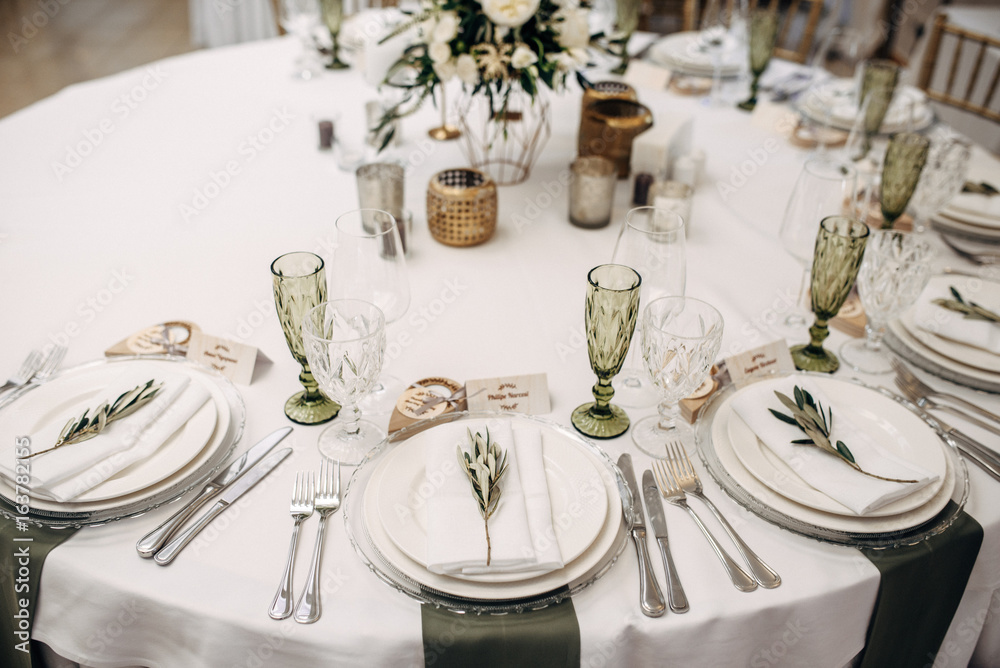 decorated table bride and groom with flasks for candles, flowers, candles and candlesticks and number of the table decorated table bride and groom with flasks for candles, flowers, candles and candlesticks and number of the table