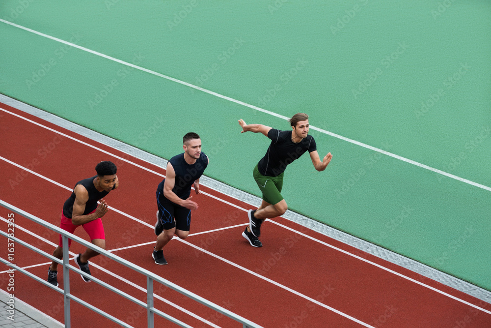 Fototapeta premium Concentrated multiethnic athlete group run