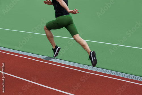 Cropped image of young caucasian athlete man run © Drobot Dean