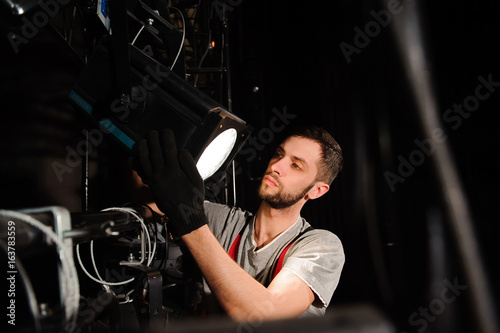 The stage worker sets up the lights