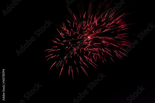 Bursting fireworks against black background