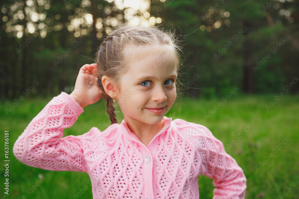 Portrait of a little girl in the park in the evening Portrait of a little girl in the park in the evening