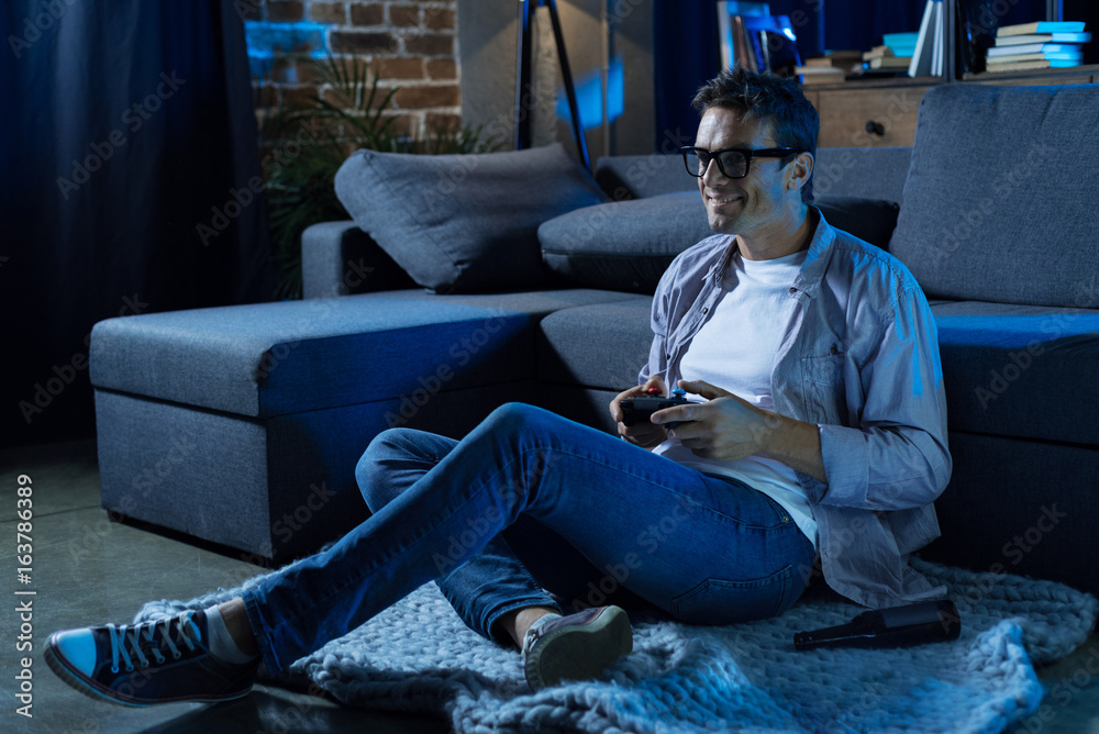 Inspired motivated guy relaxing in the living room Inspired motivated guy relaxing in the living room
