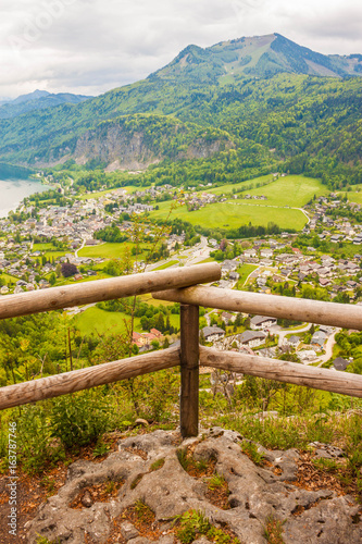Viewpoint on Plomberg mountain with wooden fence. Beautiful high up view of alpine village St. Gilgen and Zwolferhorn mountain. Austria photo