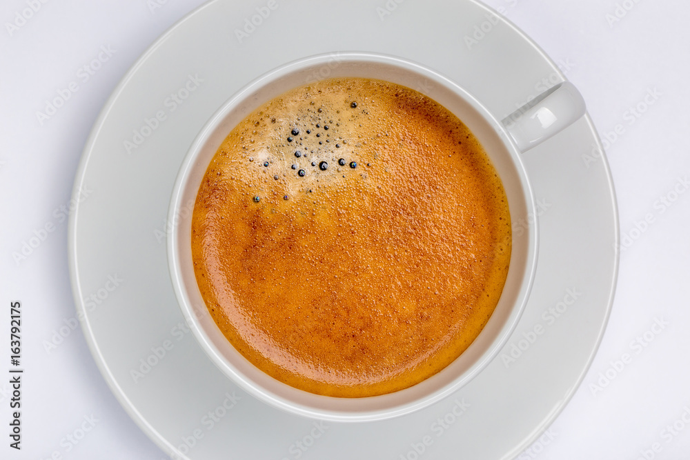 Hot black coffee with foam bubbles in white cup with white background, morning coffee concept. Hot black coffee with foam bubbles in white cup with white background, morning coffee concept.