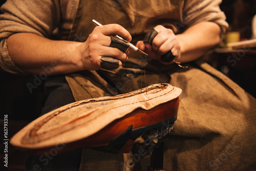 Cropped photo of young man shoemaker photo