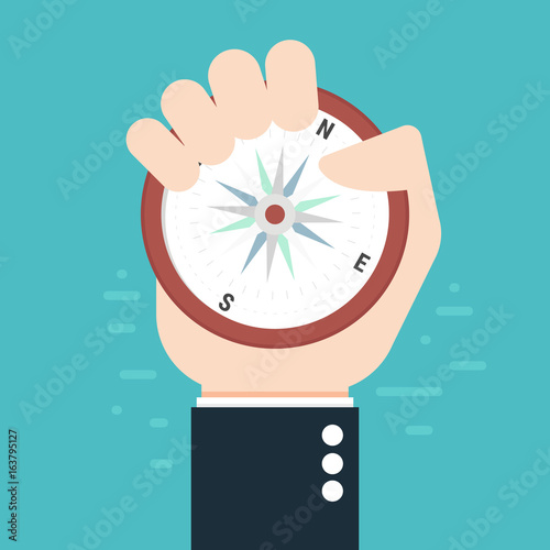 Business man holding compass